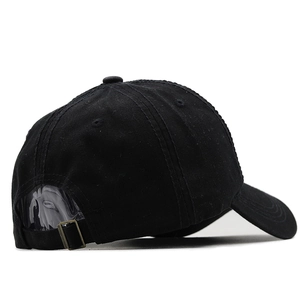Detail of adjustable metal buckle strap and breathable eyelets on black baseball cap