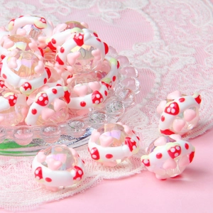 DIY acrylic beads with hand-painted mushroom patterns on pink lace background for jewelry