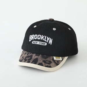 Detailed close-up of Brooklyn embroidery and leopard print brim on children's baseball cap