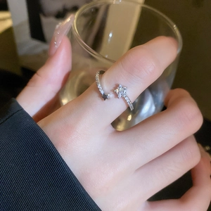 Detail of silver star-shaped adjustable ring with pavé-set zircons on hand