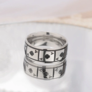 Macro view of the engraved Ace of Spades pattern on the stainless steel ring surface