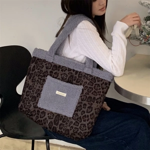 Detail showing plush leopard print stitching and grey faux fur pocket on large tote bag