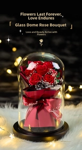 Detailed view of red soap roses in a glass dome with a 'Just for you' ribbon and wood base