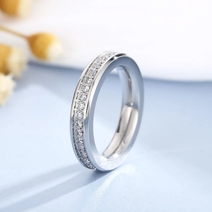 Macro shot of polished silver band ring with full eternity pave set diamonds