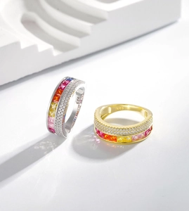 Close-up of S925 silver rings with rainbow gemstones and white zircon on white steps