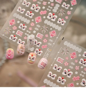 Detailed view of pink lion dance nail stickers with embossed cherry blossom patterns