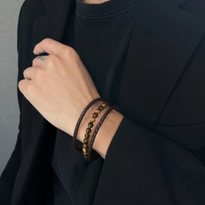 Men's tiger eye stone bead bracelet and dark brown braided leather strap set on wrist