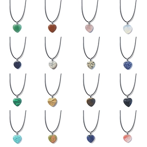Macro shot of 16 assorted 20mm heart-shaped natural stone pendants with woven cords