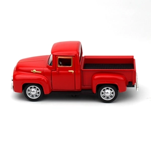 Macro side view of vintage red alloy pickup truck model with metallic finish and details
