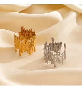 Detail of silver and gold irregular lava flow rings on beige silk fabric background