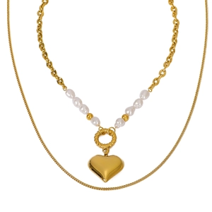 Double-layered gold heart pendant necklace with pearls on a clean white background