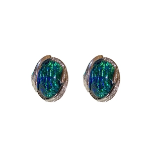 Vintage silver earrings with green opal gemstones and diamond accents on white background