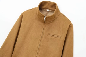 Detailed close-up of brown faux suede jacket featuring a stand collar and metal zipper