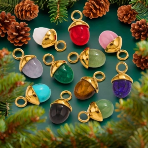 Colorful acorn-shaped natural stone pendants with gold loops on festive pine branches