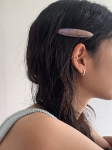 French vintage pearl ear cuff and acetate barrette set worn by a female model