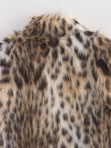 Close-up of leopard print faux fur texture showcasing soft fibers and collar detail