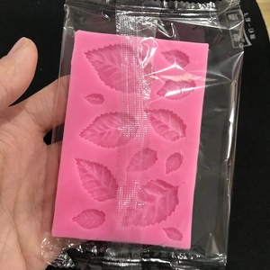 Pink silicone maple leaf fondant mold in packaging for cake decorating and DIY baking