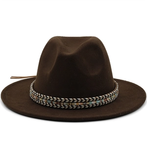 Detail of dark brown wool fedora hat featuring vintage colorful woven ethnic headband