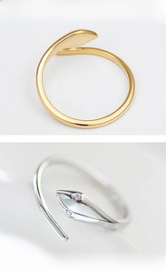 Macro detail of snake-shaped open rings with delicate pavé crystal eye accents