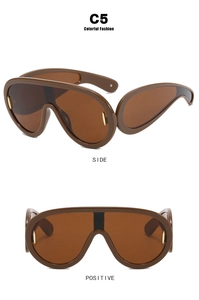 Detail view of brown oversized wrap-around sunglasses with golden metallic side accents