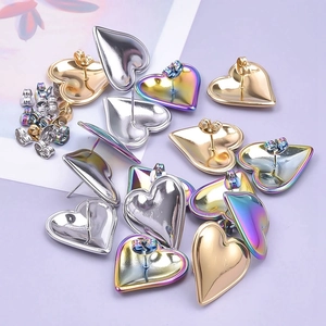 Detailed view of heart-shaped 304 stainless steel earrings in gold, silver, and aurora finishes