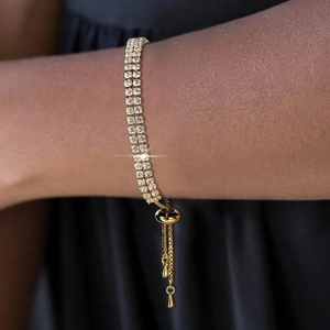 Elegant gold double-row zircon tennis bracelet with adjustable bolo slider on wrist