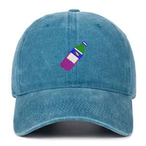 Close-up of colorful bottle embroidery on the dark blue washed denim baseball cap