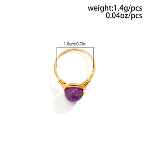 Detail view of handmade gold wire wrapped ring with purple stone and 1.8cm diameter