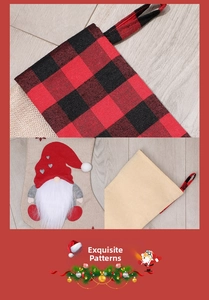 Detail of buffalo plaid Christmas stocking with gnome motif and red hanging loop