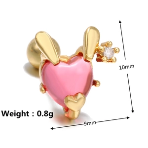 Detailed macro view showing the 10mm pink heart ear stud with golden rabbit ears and white zircon