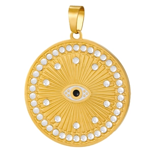 Detailed macro view of a gold-plated circular Evil Eye pendant with sparkling clear crystals