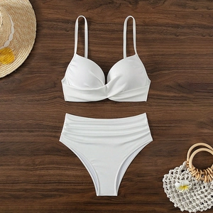 White ribbed two-piece bikini with twist front top and high-waist bottoms on wooden deck