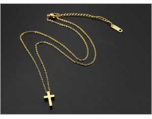 Macro shot of 18K gold plated cross pendant necklace with lobster clasp over black background