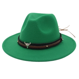 Detail of green fedora hat featuring a western bull skull metal buckle and braided straps