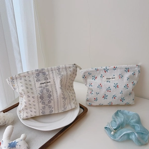 Detail of floral cotton makeup bags with zipper closure and vintage lace patterns