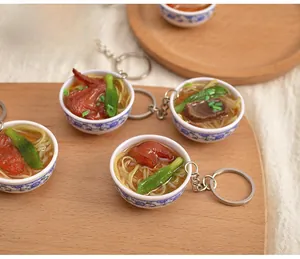 Detail of miniature noodle bowl keychain featuring realistic toppings and a floral ceramic pattern