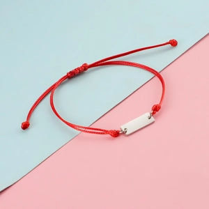 Detailed view of adjustable red braided cord with a silver rectangular polished metal tag