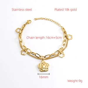 Detail view of 18k gold plated double chain bracelet with camellia flower pendant