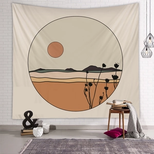 Detail of bohemian wall tapestry showing minimalist mountain sunset print in a cozy room