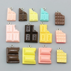 Macro shot of assorted resin chocolate charms in pastel colors for DIY jewelry crafts