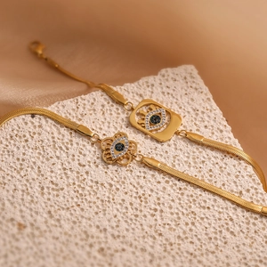 18K gold plated evil eye bracelet set with zircon stones on natural stone background