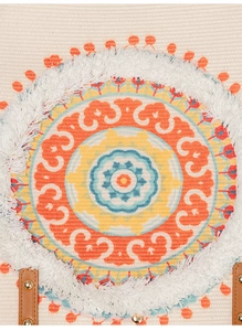 Close-up of mandala embroidery with white fringe and leather handle on canvas tote