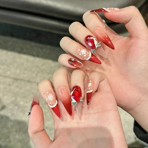 Handmade Christmas press-on nails featuring red gradient with snowflakes and crystals