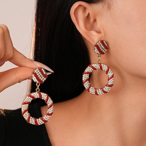 Christmas style round earrings with red and white enamel stripes and inlaid crystals