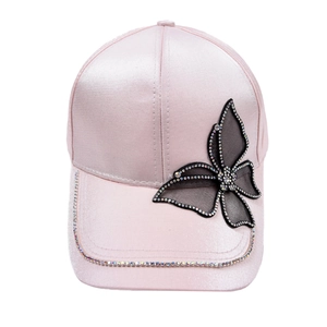 Detail of pink satin baseball cap with mesh butterfly and sparkling rhinestones