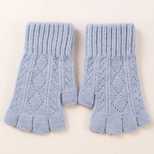 Detail view of light blue knitted fingerless arm warmers with diamond hollow pattern texture