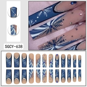 Winter snowflake press on nails with deep blue and nude colors plus rhinestone accents