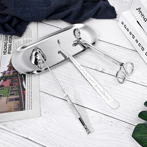 Polished silver stainless steel candle care set on tray with snuffer and wick trimmer