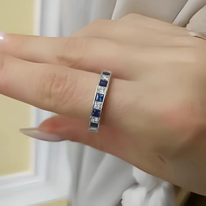 Close-up of titanium steel ring with alternating blue and clear square zircons