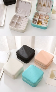 Macro shot of portable PU leather jewelry box detailing the zipper and soft velvet lining